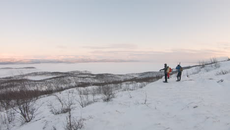 Hikers-looking-at-the-beautiful-view-during-sunrise-in-the-nature-of-northern-Sweden