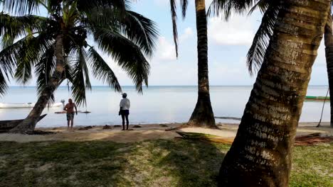 Flying-through-palm-trees-out-onto-beach-and-Indian-Ocean-in-Madagascar