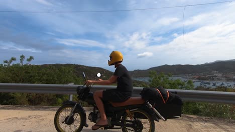 Traveling-alone-on-motorbike-along-coastal-scenic-road,-Vinh-Hy-Bay,-Vietnam