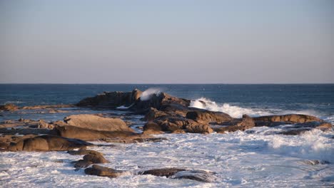 Slow-motion-shot-of-ocean-waves-crashing-on-rocks-on-coast-of-Korea