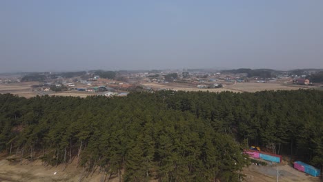 Drone-overview-of-Seosan,-rural-housing-and-commercial-area-at-South-Korean-coastal