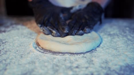 Close-up-of-the-gloved-chef's-hand-making-pizza-dough-120fps-4k