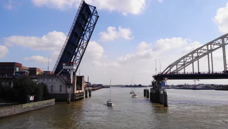 Sailboats-Crossing-At-Opened-Bascule-Bridge-Over-Noord-River-In-Alblasserdam-In-The-Netherlands