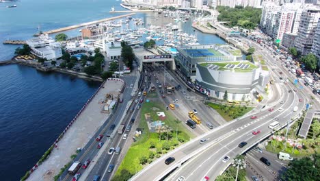 Traffic-heading-in-and-out-of-Hong-Kong-cross-harbor-tunnel,-Aerial-view