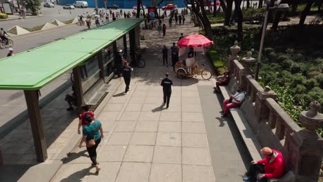 Aerial-above-people-walking-on-sidewalk-at-public-street-in-reforma,-mexico