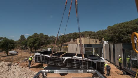 POV-Timelapse-of-a-prefabricated-swimming-pool-being-lifted-into-place