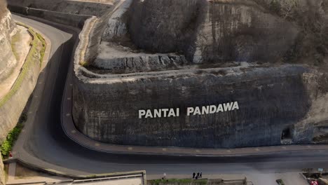 Pantai-Pandawa-name-on-wall-cliff-and-the-road-to-famous-beach-on-Bali-Indonesia