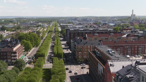 Main-alley-road-of-Norrkoping-and-cityscape,-aerial-side-flying-view