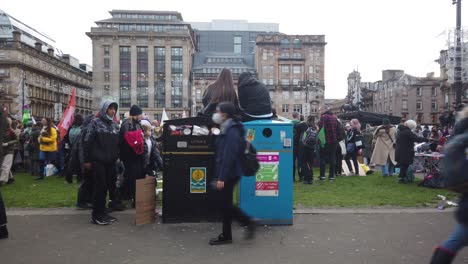 Two-girls-sitting-on-two-public-bins