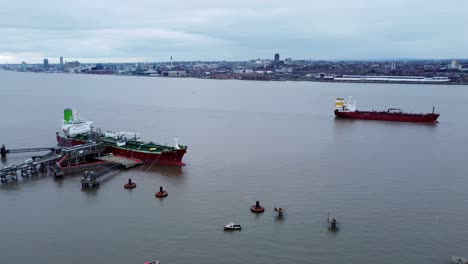 Silver-Rotterdam-oil-petrochemical-shipping-tanker-loading-on-river-Mersey-Liverpool-aerial-view-pan-right