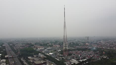 aerial-shot,-a-radio-transmitting-tower-in-the-middle-of-the-city