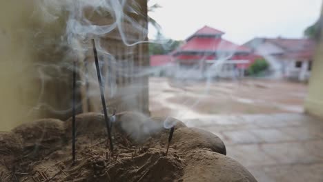 Close-up-static-view-of-smoke-coming-out-of-the-burning-incense-in-front-of-an-Asian-Buddhist-temple-in-Sri-Lanka