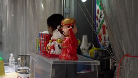 Chai-Shen-Ye-,-God-of-Wealth,-at-street-stall,-Chinatown,-Singapore