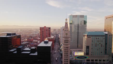 Drone-Aerial-View-Of-Downtown-Denver-Colorado-Skyline-Showing-Lannies-Tower-Landmark-And-Surrounding-High-Rise-Buildings-During-Sunset