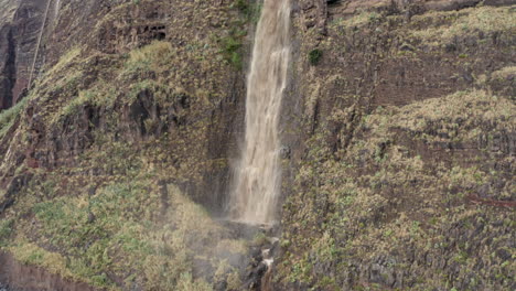 A-Waterfall-Cascading-Down-A-Lush-Cliff---aerial-drone-shot