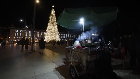 A-man-sells-chestnuts-in-the-streets-of-Lisbon,-Portugal,-during-Christmas-time