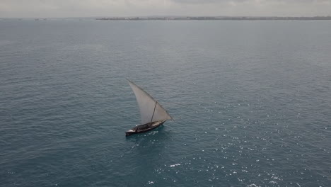 Traditional-dhow-sailboat-off-Zanzibar-coast:-Amazing-orbiting-aerial