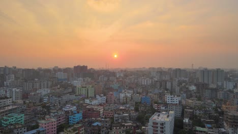 Drone-descent-revealing-Dhaka-Khilgaon-cityscape-of-colorful-buildings-at-sunset