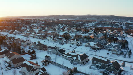 Sunset-over-a-snow-covered-suburban-neighborhood-on-a-winter-evening