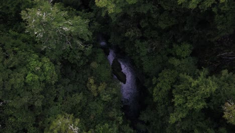 Aerial-looking-down-into-beautiful,-dark,-river-gorge