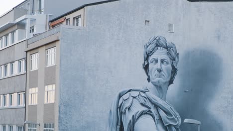Tilt-up-from-Mural-painting-of-Julio-Cesar-Portrait,-world-best-graffiti-2021,-Lugo