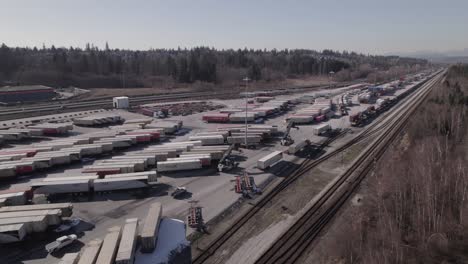 Aerial-view-of-reach-stacker-trolleys-driving-in-logistic-center-of-Vancouver-shipping-terminal-in-Canada