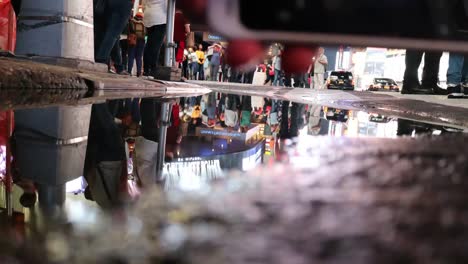 People-in-Times-Square-Rain-Puddle-Reflection,-Timelapse
