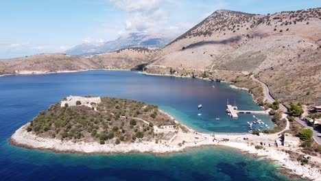 Porto-Palermo-Castle,-Albania---Aerial-of-Peninsula-Island,-Bay-and-Coastal-Road