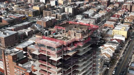 A-high-angle-view-above-a-new-high-rise-construction-site-in-Brooklyn,-NY