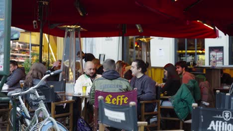 Friends-Hang-Out,-Dine-In,-And-Drinking-Beer-On-The-Heated-Tents-After-Brussels,-Belgium-Lift-COVID-19-Restrictions