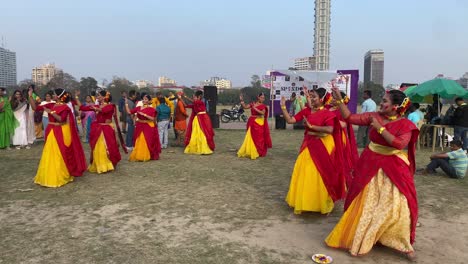 The-celebration-with-dance,-music-with-colorful-costume-in-the-festival-of-color-called-Holi-or-Basanta-Utsav,-in-spring-at-Maidan-near-the-building-"the-42