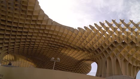 Slow-motion-pan-looking-up-to-Los-Zetas-architecture-in-Seville,-Spain