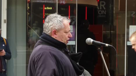 Intense-male-public-performer-on-city-street-singing-opera-music-to-the-crowd