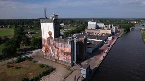 Slow-aerial-rotating-movement-around-factory-storage-facility-along-the-Twentekanaal-waterway-canal