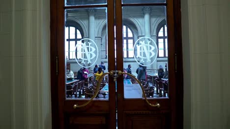 Handheld-of-the-doors-with-the-symbol-of-the-emblem-of-the-coat-of-arms-of-the-National-Library-of-Chile,-Gabriela-Mistral-Reading-Room,-Santiago,-Chile