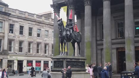 Slow-motion-of-people-posing-next-to-the-Duke-of-Wellington-statue
