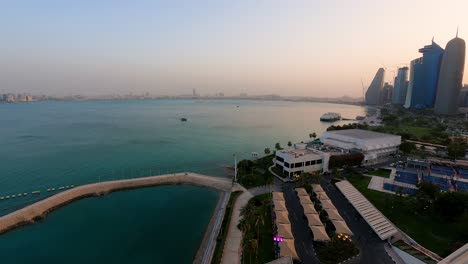 Boats-in-the-port-of-Doha,-Qatar-with-a-view-of-the-city-skyline---time-lapse