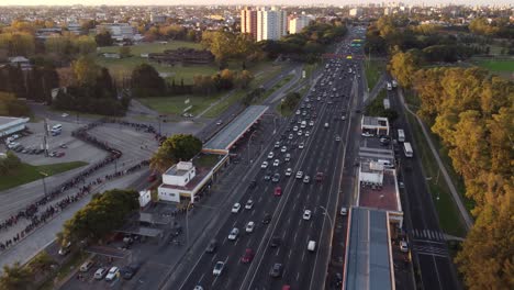 Aerial-flyover-high-frequented-highway-with-skyline-of-Buenos-Aires-ibn-background-during-sunset