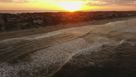 Revealing-drone-shot-of-the-sun-setting-on-the-Outer-Banks,-NC