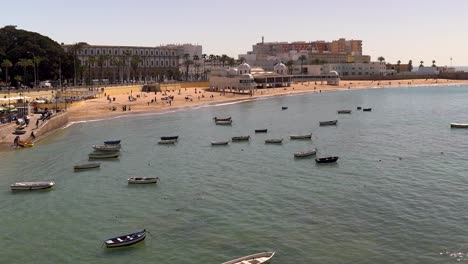 Slow-pan-across-small-fishing-boats-parked-in-harbor-of-Cadiz