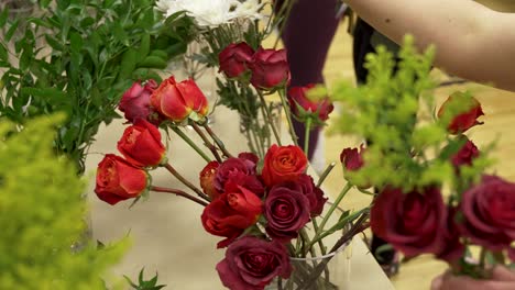 Florists-preparing-for-a-wedding-or-special-event-gathering-flowers-for-center-pieces-and-bouquets