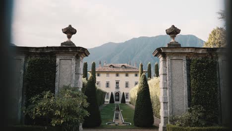 Tilt-reveal-through-the-main-front-gate-gate-lattice-of-famous-Villa-Balbiano-at-lake-como-luxury-wedding-venue-location-like-a-tourist
