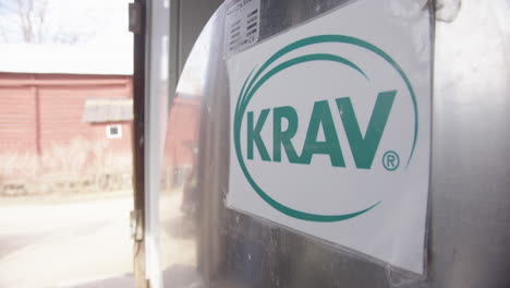 HANDHELD---A-KRAV-organic-certification-sign-on-a-stainless-steel-milk-tank