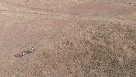 Drone-following-mountain-bikers-on-a-trail-in-a-slow-motion-during-winter-time