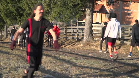 Men-exercising-outside-in-cool-weather-race-each-other-on-dirt-farm-road