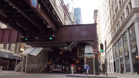 Chicago-L-Passes-Over-Downtown-Street-With-People