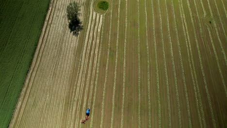 Aerial-Top-View-Of-A-Tractor-Plowing-Agricultural-Field