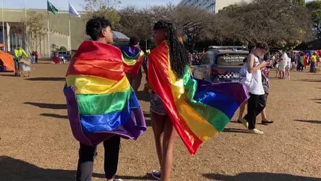 colorfully-dressed-in-rainbow-flags-people-walk-over-the-terrain-of-the-gay-pride-parade-in-the-city-of-brasilia-where-the-police-is-present-to-keep-the-law-and-order