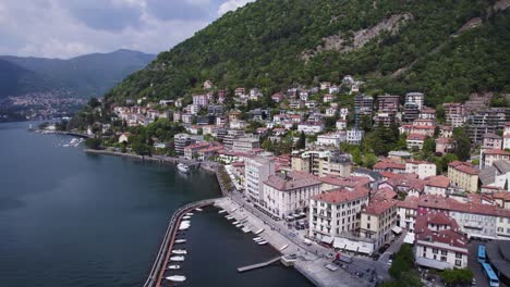 Buildings-and-Hotels-on-Shoreline-of-Beautiful-Lake-Como,-Italy---Aerial