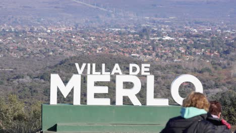 Tourists-on-a-lookout-with-view-of-Villa-de-Merlo-on-the-valley